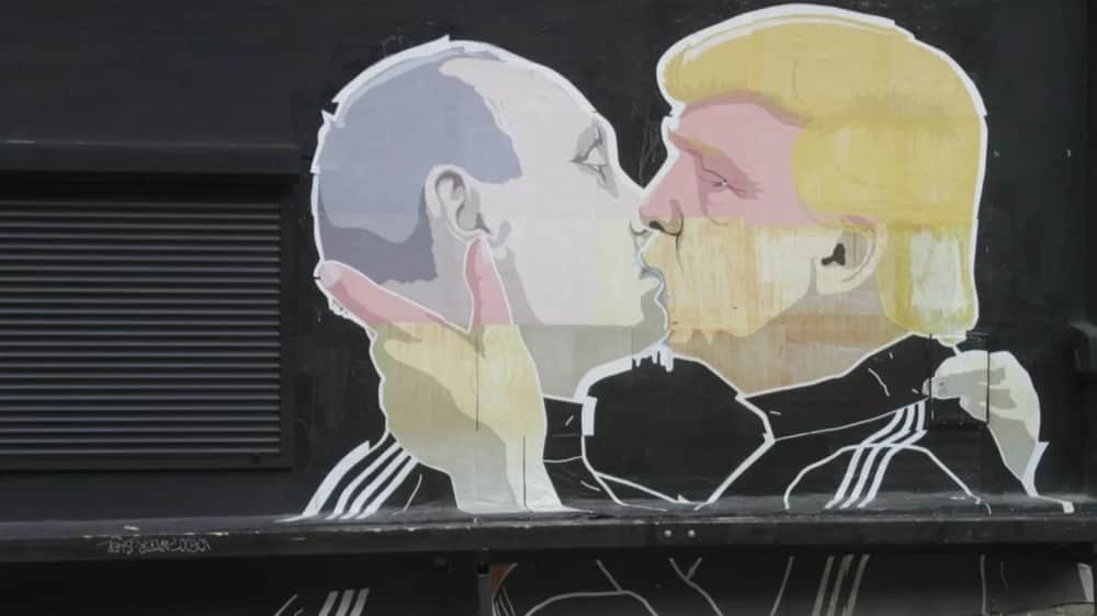 A mural by Lithuanian artist Mindaugas Bonanu depicting former US President Donald Trump kissing Vladimir Putin. Vilnius, Lithuania, 04 August 2016. EPA/VALDA KALNINA