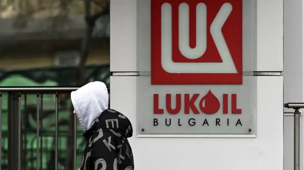 A man walks past the logo of Russian oil company Lukoil in Sofia, Bulgaria, 7 December 2023. Photo: EPA/VASSIL DONEV