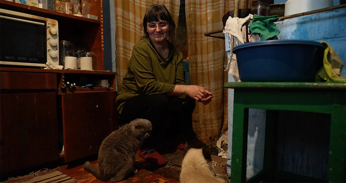 Natalia at the stove. <a href="https://www.youtube.com/watch?v=NjrPBmXX3vo" rel="noopener noreferrer" title="https://www.youtube.com/watch?v=NjrPBmXX3vo">A shot from the film “Firewood for the mobilised”</a>