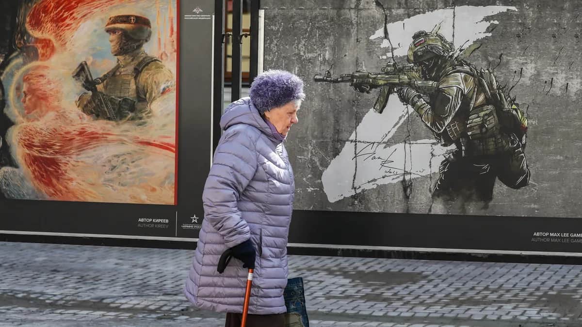 An elderly woman walks past a street art exhibition called We Bring Peace! in Moscow, Russia, 5 April 2024. Photo: EPA / YURI KOCHETKOV