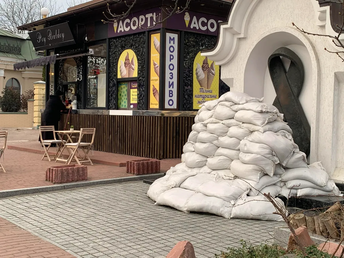 Мемориальный знак «ленточка» в память людей, умерших от СПИДа до середины укрыт мешками с песком — чтобы не поранило осколками. Фото: Ольга Мусафирова, специально для «Новой газеты Европа»