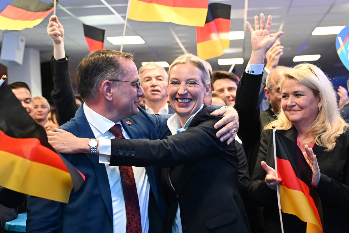 Сопредседатели партии «Альтернатива для Германии» (AfD) Алис Вайдель (в центре) и Тино Хрупалла (слева) реагируют на первые результаты выборов на партийном митинге, Берлин, 23 февраля 2025 года. Фото: Soeren Stache / EPA